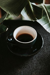 Coffee in a black cup in a cafe