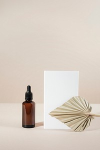 Brown glass dropper bottle with a white box product mockup