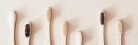 Bamboo toothbrushes on a beige background