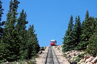 Both coming and going are steep for the Pikes Peak Cog Railway, which ascends Colorado&#39;s famous 14,115-foot Pikes Peak from its base station far below in Manitou Springs.