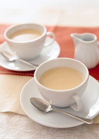 Free tea with milk, white saucer photo, public domain beverage CC0 image.