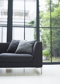 Comfy Sofa With Cushions Against Glass Windows In The Living Room