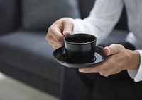 Free man having coffee, sitting in living room photo, public domain beverage CC0 image.