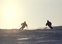 Silhouettes Two Guys On Skis On The Mountain