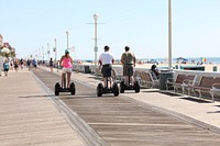 Free people using segway in city boardwalk image, public domain travel CC0 photo.