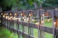 String Of Lights, Exterior, Yellow Bulbs On Old Wooden Fence