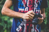 Man holding a camera, free public domain CC0 image.