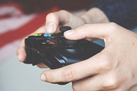 Free hand holding gaming console photo, public domain CC0 image.