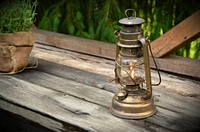 Free lit lantern on wooden table image, public domain CC0 photo.