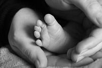 Mother holding baby feet. Free public domain CC0 photo.