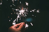 Person holding sparklers. Free public domain CC0 photo.