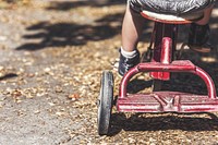 Free close up kid biking 3 wheel bike image, public domain CC0 photo.