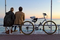 Free couple sitting next to a bike image, public domain scenery CC0 photo.