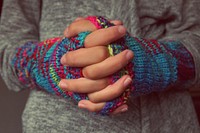 Free knitted gloves on hands photo, public domain CC0 image.