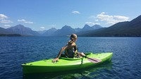 Free woman in a kayak enjoying the view of mountains image, public domain CC0 photo.