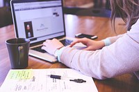 Free woman working with laptop, notebook and coffee cup on table image, public domain CC0 photo.