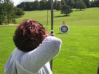 Free woman aiming bow and arrow towards target image, public domain sport CC0 photo.