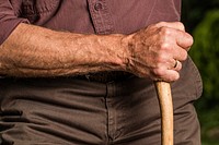 Free man holding wood stick image, public domain human CC0 photo.