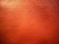 Orange leather background, free public domain CC0 photo.