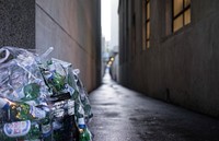 Free beer bottle in plastic bag image, public domain CC0 photo.