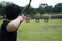 Free man aiming bow and arrow towards target image, public domain sport CC0 photo.