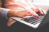 Woman working on laptop, free public domain CC0 photo.