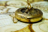 Golden compass on map, free public domain CC0 image.