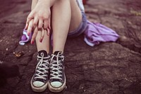 Girl sitting alone on rock, free public domain CC0 image.