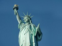 Liberty statue in blue sky background image, free public domain CC0 photo.