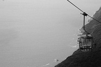 Free cable car next to the sea in black and white image, public domain CC0 photo.