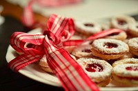 Free strawberry jam biscuits on a plate with red ribbon image, public domain dessert CC0 photo.