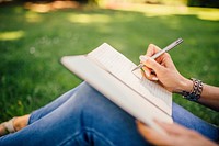 Free close up of a hand writing notes in a journal photo, public domain CC0 image.