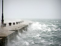 Stormy sea waves crashing dock, free public domain CC0 photo.