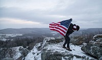 Person holding American flag image, free public domain CC0 photo.