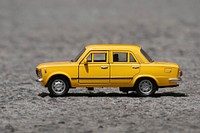 Miniature yellow vintage car. Free public domain CC0 photo.