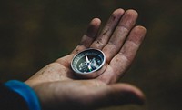 Free hand holding compass image, public domain CC0 photo.