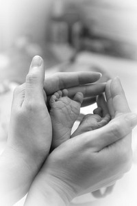 Mother holding baby feet. Free public domain CC0 photo.