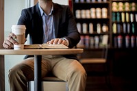 Free a businessman holding a coffee cup photo, public domain drink CC0 image.