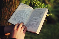 Free person reading a book closeup photo, public domain book CC0 image.