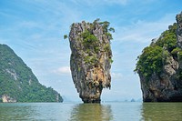 Island with cliff, rocks, caves, free public domain CC0 photo.