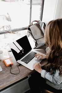 Woman working on laptop, free public domain CC0 photo.