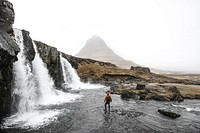 Man standing under waterfall monochromatic photography, free public domain CC0 photo.