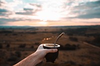 Free cocoa, coffee, steel straw, beach background photo, public domain beverage CC0 image.