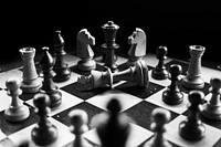 Free chess board with pieces, black and white photo, public domain game CC0 image.