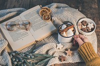 Free flat lay reading book in bed with hot chocolate photo, public domain CC0 image.