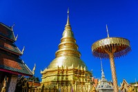 Golden pagoda with blue sky background, free public domain CC0 photo.