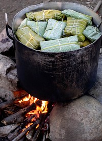 Free banana leaf wrapped food steaming over fire image, public domain CC0 photo.