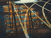 Free reflection of apartment building and tree on water on running lane image, public domain CC0 photo.