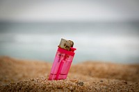 Free lighter stuck in sand image, public domain CC0 photo.