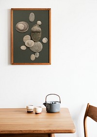 Wooden picture frame mockup psd with zen stones photo on the wall interior concept